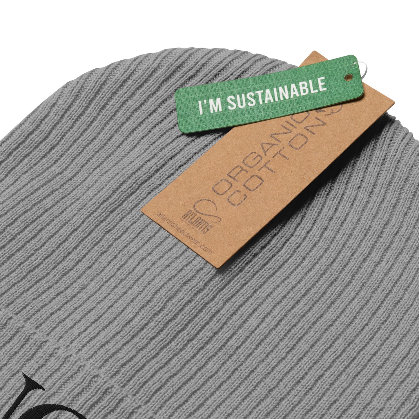 Finely ribbed grey beanie by Nørvael. The focus is on the black "NØ" logo embroidery on the folded cuff of the hat.